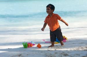 Boy on beach at Constance Halaveli Resort