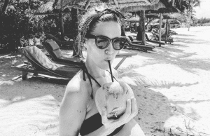 Laura Fantacci drinking some coconut water during her stylish babymoon